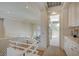 Hallway with white railings, and a view of the neighborhood through sliding glass doors at 8221 Crow Valley Ln, Las Vegas, NV 89113