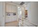 Hallway featuring white storage cabinets, modern railing, and tile floors at 8221 Crow Valley Ln, Las Vegas, NV 89113