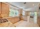 Modern kitchen with stainless steel appliances, granite countertops, and views of the outdoor greenery at 8221 Crow Valley Ln, Las Vegas, NV 89113