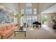 Spacious living room boasts tall windows, a grand piano, and access to the outdoor space at 8221 Crow Valley Ln, Las Vegas, NV 89113