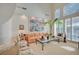Open living room featuring high ceilings, neutral decor, and a comfortable seating arrangement at 8221 Crow Valley Ln, Las Vegas, NV 89113
