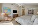 Spacious main bedroom with a vaulted ceiling, ceiling fan, and a comfortable sitting area with natural light at 8221 Crow Valley Ln, Las Vegas, NV 89113