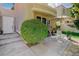 Private outdoor patio area with elegant seating, lush greenery, and stone pavers at 8221 Crow Valley Ln, Las Vegas, NV 89113