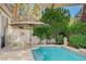 Inviting backyard pool featuring a patio with lounge chairs and lush landscaping at 8221 Crow Valley Ln, Las Vegas, NV 89113