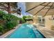 Refreshing pool with waterfall feature surrounded by lush greenery and outdoor seating at 8221 Crow Valley Ln, Las Vegas, NV 89113