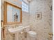 Charming powder room with decorative wallpaper, pedestal sink, and gold accents at 8221 Crow Valley Ln, Las Vegas, NV 89113