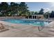 Sparkling community swimming pool with lounge chairs and covered area, perfect for relaxation and recreation at 8221 Crow Valley Ln, Las Vegas, NV 89113