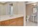 An elegant bathroom with a pedestal sink, a spacious mirror, and wooden cabinets at 8255 S Las Vegas Blvd # 1404, Las Vegas, NV 89123