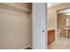 Walk-in closet view opening to a bathroom with vanity and tile floor at 8255 S Las Vegas Blvd # 1404, Las Vegas, NV 89123