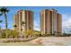 Upscale condominium complex showcasing sleek modern architecture and balcony views in a desirable location, enhanced with mature palm trees at 8255 S Las Vegas Blvd # 1404, Las Vegas, NV 89123