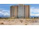 Contemporary high-rise condominium with multiple balconies, offering stunning views and modern architectural design against a blue sky at 8255 S Las Vegas Blvd # 1404, Las Vegas, NV 89123