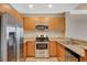 Kitchen with stainless steel appliances, wood cabinets and breakfast bar overlooking living area at 8255 S Las Vegas Blvd # 1404, Las Vegas, NV 89123