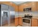 Close-up of kitchen featuring stainless steel appliances, light wood cabinets, and granite countertops at 8255 S Las Vegas Blvd # 1404, Las Vegas, NV 89123
