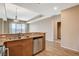 Open kitchen features stainless steel dishwasher, granite countertops, and a view of the living area at 8255 S Las Vegas Blvd # 1404, Las Vegas, NV 89123