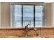 A sink sits in front of sliding glass doors showing city and mountain views at 8255 S Las Vegas Blvd # 1404, Las Vegas, NV 89123