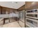 Well-equipped kitchenette with stainless steel appliances, granite countertops, and custom cabinetry at 8255 S Las Vegas Blvd # 1404, Las Vegas, NV 89123