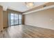 Bright living room featuring wood floors, neutral walls, and sliding glass doors with a city view at 8255 S Las Vegas Blvd # 1404, Las Vegas, NV 89123