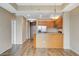 Open-concept living area featuring wood-style flooring and a kitchen with stainless appliances at 8255 S Las Vegas Blvd # 1404, Las Vegas, NV 89123