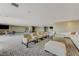 Expansive lounge area with diverse seating, a television, and ample natural light offering a versatile space at 8255 S Las Vegas Blvd # 1404, Las Vegas, NV 89123