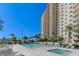 Luxury high-rise building overlooking pool with spa, lounge chairs, palm trees, and inviting landscaping at 8255 S Las Vegas Blvd # 1404, Las Vegas, NV 89123