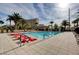 Outdoor pool with lounge chairs, lush landscaping, and community recreation area in a high-rise setting at 8255 S Las Vegas Blvd # 1404, Las Vegas, NV 89123