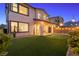 Backyard boasts a putting green, patio area, and desert landscaping under string lights at 828 Parker Mesa St, Las Vegas, NV 89138