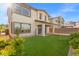 Expansive backyard with an artificial putting green, native landscaping, and an inviting covered patio area at 828 Parker Mesa St, Las Vegas, NV 89138