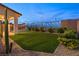 Backyard putting green with patio, decorative lighting, landscaping and desert plants at 828 Parker Mesa St, Las Vegas, NV 89138