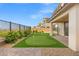 Well-manicured backyard featuring a putting green, desert plants and a covered patio at 828 Parker Mesa St, Las Vegas, NV 89138