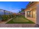 The backyard features a putting green, patio, and landscaping with string lights at 828 Parker Mesa St, Las Vegas, NV 89138