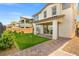 Landscaped backyard showcasing an artificial putting green and a covered patio area at 828 Parker Mesa St, Las Vegas, NV 89138