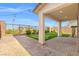 Picturesque backyard featuring an artificial putting green, covered patio, and manicured landscaping at 828 Parker Mesa St, Las Vegas, NV 89138