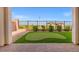 View of backyard with an artificial putting green and patio under a covered porch at 828 Parker Mesa St, Las Vegas, NV 89138
