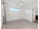 A bright bedroom is accentuated with a horizontal window and has carpet flooring and white walls at 828 Parker Mesa St, Las Vegas, NV 89138