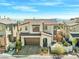 Two-story home with desert landscaping, paved driveway, and brown garage door at 828 Parker Mesa St, Las Vegas, NV 89138