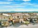 Two-story stucco home with desert landscaping and brown garage door in community at 828 Parker Mesa St, Las Vegas, NV 89138