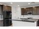 Modern kitchen with dark cabinets, an island, and stainless steel appliances at 828 Parker Mesa St, Las Vegas, NV 89138
