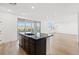 Kitchen island with sink and dark cabinets in a bright, open-concept space at 828 Parker Mesa St, Las Vegas, NV 89138