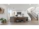 Bright living room features wood floors, a staircase, sofa, and lots of natural light at 828 Parker Mesa St, Las Vegas, NV 89138