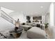 Stylish living room featuring modern furnishings, a staircase, and an open layout leading to the kitchen at 828 Parker Mesa St, Las Vegas, NV 89138