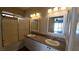 Bathroom featuring dual sinks, granite countertops, and a shower/tub combo at 83 Rock Run St, Las Vegas, NV 89148