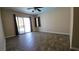 Bedroom with tile floors, ceiling fan, and sliding glass door leading to outdoor area at 83 Rock Run St, Las Vegas, NV 89148