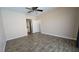 Large, bright bedroom featuring tile floors, a ceiling fan, and a door to the bathroom at 83 Rock Run St, Las Vegas, NV 89148
