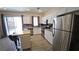 Well-lit kitchen featuring stainless steel appliances, white cabinetry, and a movable kitchen island at 83 Rock Run St, Las Vegas, NV 89148