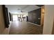 Living room area with tile flooring, wood accent wall, hallway and doorway leading to other rooms at 83 Rock Run St, Las Vegas, NV 89148