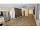 Open-concept living room with tile flooring, a ceiling fan, neutral paint, and lots of natural light at 83 Rock Run St, Las Vegas, NV 89148