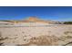Expansive desert lot with views of a striking mountain and nearby houses at 83 Rock Run St, Las Vegas, NV 89148