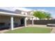 An outdoor covered patio with artificial grass and a fire pit create an inviting backyard space at 857 Lantham Pl, Las Vegas, NV 89110