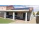 The covered backyard patio with solar panels offers shade and sustainability to this beautiful outdoor space at 857 Lantham Pl, Las Vegas, NV 89110