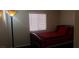 Bedroom with dark wood floors, red bedding, and a cozy atmosphere at 857 Lantham Pl, Las Vegas, NV 89110